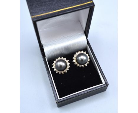 A Pair Of 18ct. Gold Diamond And Grey Pearl Set Ear Studs, each set with a grey pearl surrounded by diamonds 