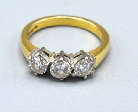 An 18ct. Yellow Gold Three Stone Diamond Ring set  within a pierced setting, approximately 0.90 ct. 4.8 gms. ring size M 