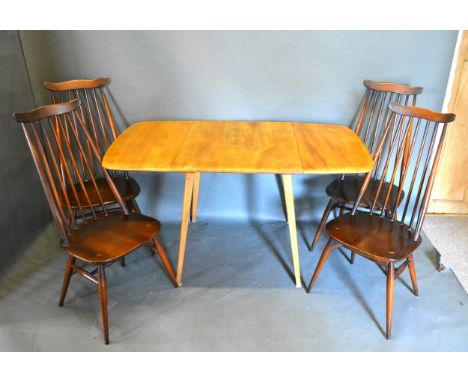 An Ercol Drop Flap Dining Table, 137 x 74 cms, 71cms high, together with a set of four Ercol stick back chairs 