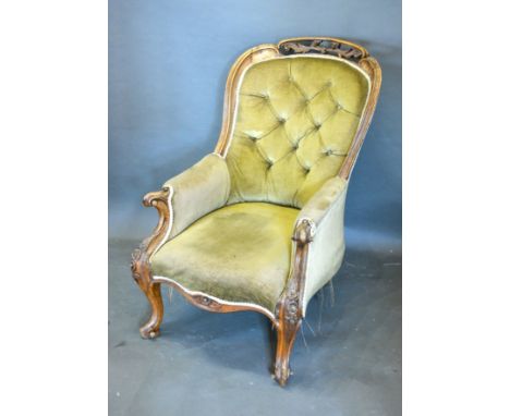 A Victorian Walnut Drawing Room Armchair, the button upholstered back above a stuff over seat raised upon carved scroll feet 