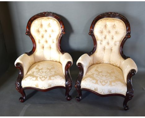 A Pair Of Victorian Style Drawing Room Armchairs, each with a carved and button upholstered back above a stuff over serpentin