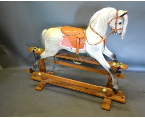 A Dapple Grey Rocking Horse with wooden stand, 124cms long 