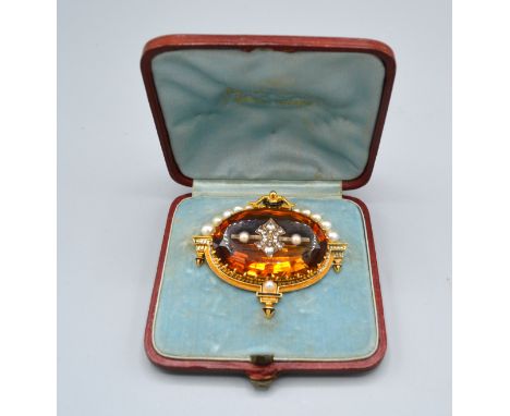 A 19th Century Brooch retailed by Tiffany &amp; Co. set with a large orange topaz encrusted with diamonds, set with graduated