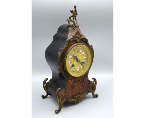 A 19th Century Boulle and Gilt Metal Mounted Mantle Clock of shaped form, the gilt dial with Roman numerals and two train str