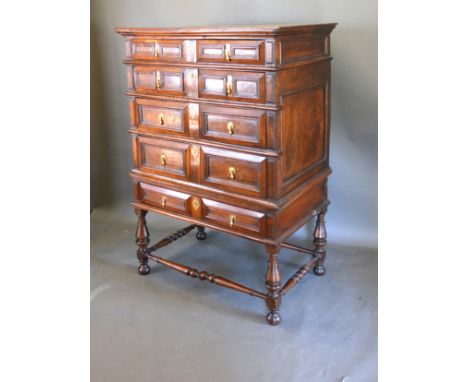A 17th Century Oak Chest On Stand with five geometrically moulded drawers with brass drop handles and escutcheons, the later 