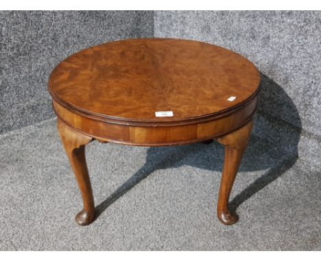 A walnut veneer low circular lamp table