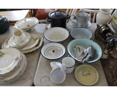 A quantity of enamel items to include bowls, a pot and cover; cup and a quantity of measuring cups 