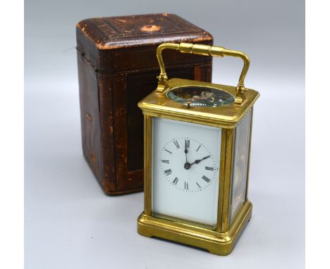 A French Brass Cased Carriage Clock with repeater movement, lever escapement, the enamel dial with Roman numerals with leathe