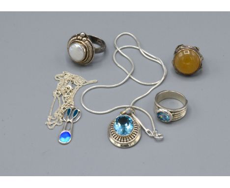 A Silver and Enamel Set Pendant with chain together with another similar pendant and chain and three silver dress rings 