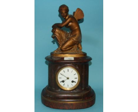 A French mantel clock, the white enamel dial with Roman numerals, in a marble base applied a winged figure, 42.5 cm high