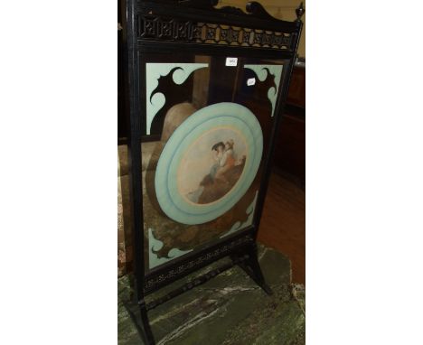 An ebonised firescreen, inset a glass panel, 55 cm wide