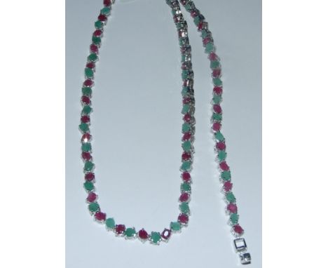 A silver, ruby and emerald necklace, and matching bracelet (2)