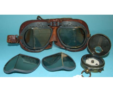 An early 20th century brass compass, a pair of Mk VIII goggles, box, and a small group of stamps