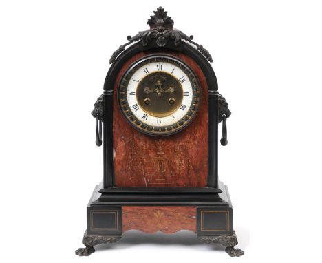 A late Victorian mantel clock, the 9cm diameter enamel dial with Roman numerals and exposed escapement, fitted an eight day m