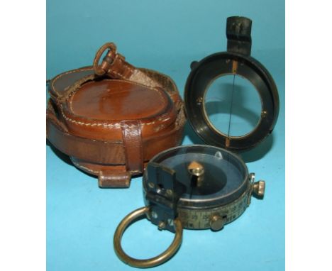 A WWI compass, in a leather case, stamped C E Mitchell