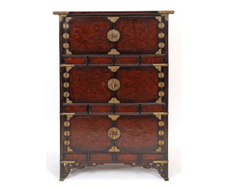 A Korean cabinet, incorporating three pairs of panel doors, and with brass mounts with engraved decoration, 107 cm wide  See 