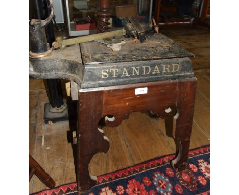 A set of STANDARD WEIGHING SCALES, with gilt decoration, on a wooden stand, 70 cm high