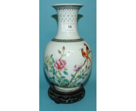 A Chinese porcelain vase, decorated birds and flowers in enamel colours, 21 cm high, with a hardwood stand (drilled)