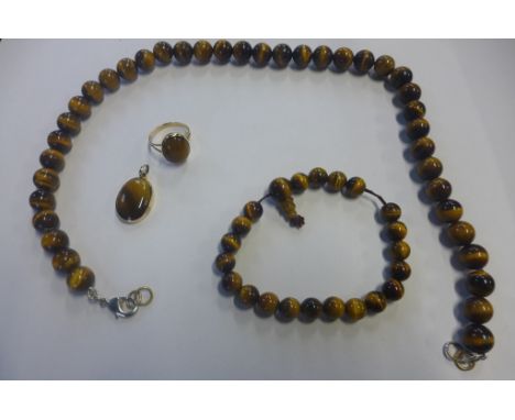 A gold and tigers eye pendant, gold and tigers eye ring, tested as 18ct, pendant measures 12mm in length, tested as 18ct, tog