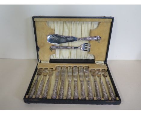 A boxed six setting fish cutlery set with silver handles, generally good, box worn 