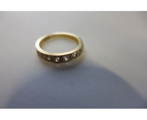 An 18ct gold and diamond half eternity ring, set with nine old European cut diamonds, the largest measuring approx 6 points, 