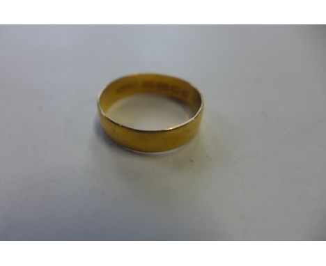 A hallmarked 22ct yellow gold band ring, size R, approx 3.3 grams, general usage marks 