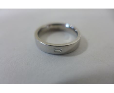 A platinum and diamond ring, size L, approx 7.9 grams, some marks consistent with usage 