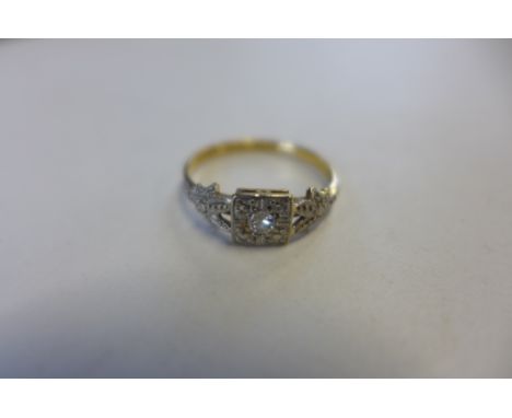 An 18ct gold platinum and diamond solitaire Art Deco style ring, the diamond measuring 0.05cts, or 5 points, set in a platinu