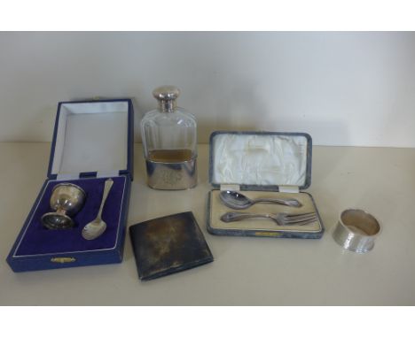 A boxed silver christening set and a mixed set, a silver serviette ring, a silver top hip flask and a silver cigarette case, 