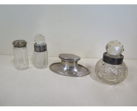 A silver Capstan inkwell, two silver rimmed bottle and a silver top bottle 