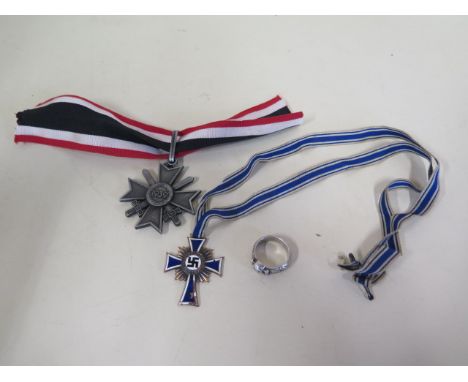 A 1938 German mothers medal, a copy 1939 medal and a copy skull and crossbones ring, chipping to enamel on mothers medal 