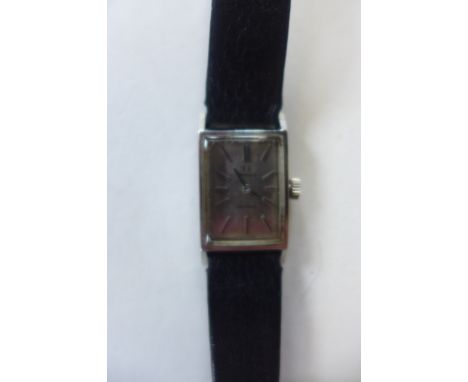 A ladies Omega manual wind wristwatch, on a leather strap, 17mm wide, including winder, generally good, running 