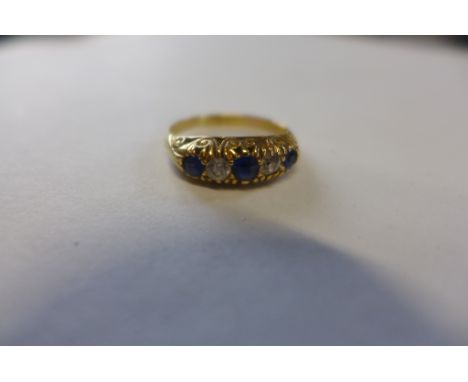 An 18ct diamond and sapphire Edwardian style ring, set with three round cut sapphires with two diamonds between, ring size K 