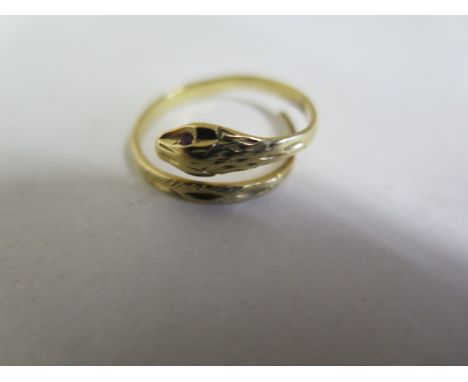 A yellow metal, single loop snake ring, textured and diamond cut detail throughout, two synthetic ruby eyes, not hallmarked, 