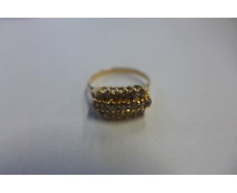 An 18ct diamond ring, stamped 750 and tested as 18ct, set with three rows of small diamonds, total of nineteen diamonds, ring