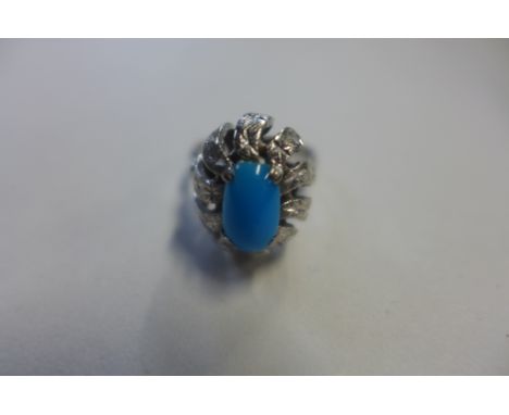 An 18ct white gold and turquoise ring, the shank stamped 750 but tested as 9ct with 18ct wash, the oval cabachon turquoise me