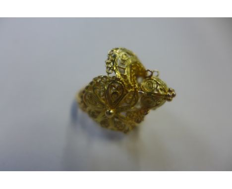 A yellow metal filigree ring, not hallmarked but tested to 18ct, size K 1/2 - weight approx 8.7 grams - good condition, light