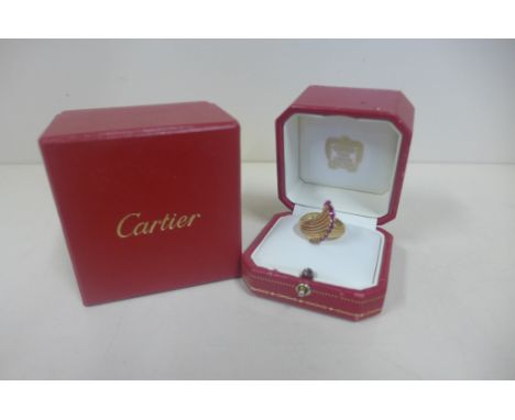 An 18ct yellow gold Cartier ring, fluted swept design set with Cartier signature, with ring box and outer box, some usage but