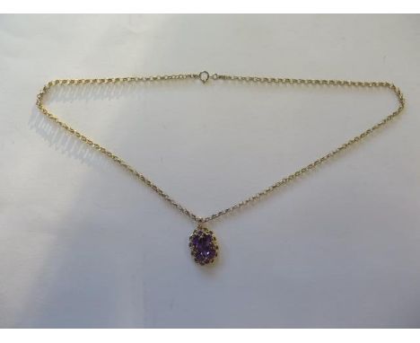 A 14ct yellow gold amethyst pendant on a modern 9ct chain, total weight approx 6 grams, pendant 2cm x 1.5cm - in good conditi