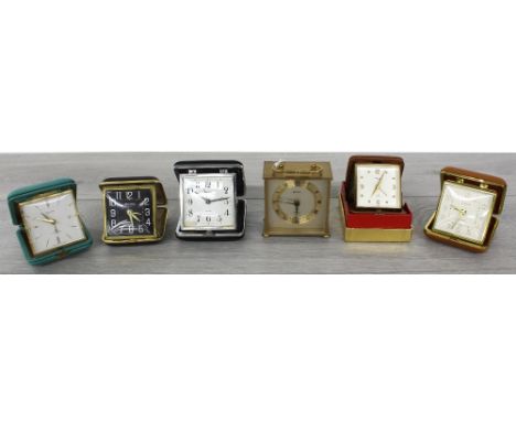 Selection of five folding travel clocks in cases;&nbsp;to include Bulova,&nbsp;Smiths, Swiza, etc.; also a Estyma small trave