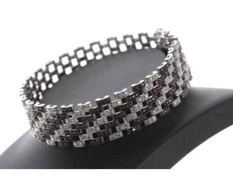 Attractive silver treated black and white diamond silver set gate bracelet, width 17mm, 30gm, marked 'TJC', 8" long 