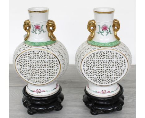 Pair of modern Chinese reticulated porcelain vases, of baluster flask form with gilt highlighted elephant head handles and de