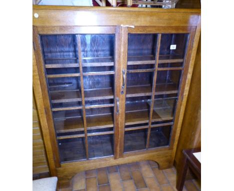 TWO DOOR BOOKCASE. Light oak glazed two door bookcase, 106 x 134cm