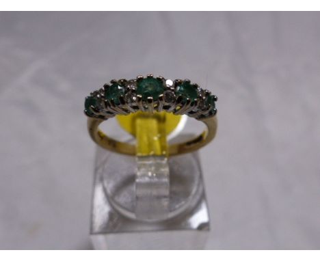 EMERALD AND DIAMOND RING. 9ct gold emerald and diamond half eternity ring, size L