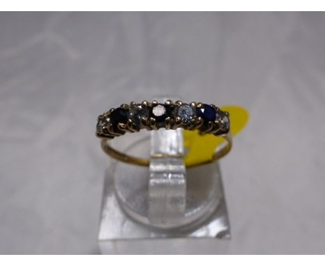 SAPPHIRE AND CZ ETERNITY RING. 9ct gold sapphire and CZ seven stone half eternity ring, size L