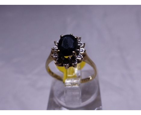 SAPPHIRE AND CZ CLUSTER RING. 9ct gold sapphire and CZ cluster ring, size I