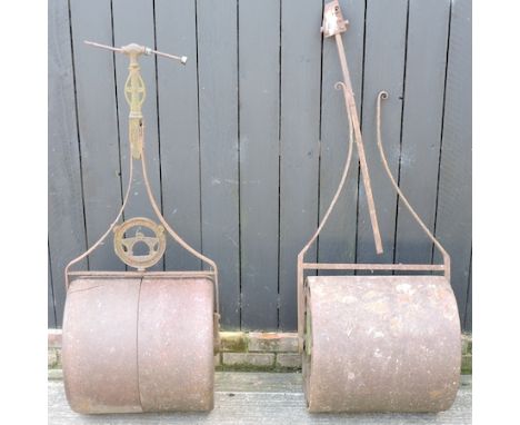 A garden roller, together with another, 51cm tall 