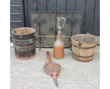 A copper bound bucket, together with another, a fire guard, 82cm, a copper table lamp and a pair of bellows