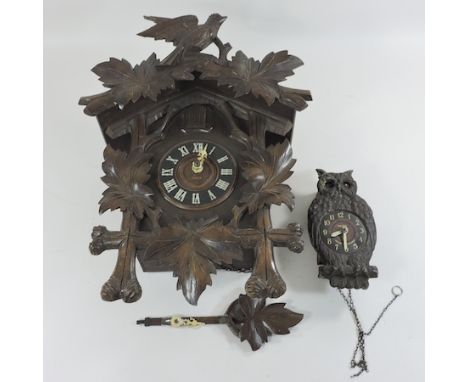 A Victorian carved cuckoo clock, 46cm tall, together with a carved clock in the form of an owl, with moving eyes
