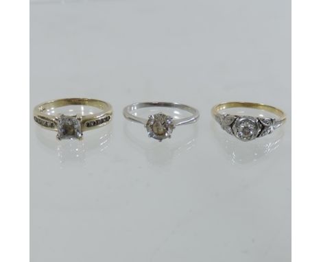 An unmarked diamond single stone ring, together with two others, boxed